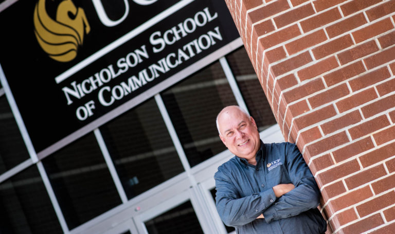 Rick Brunson posed in front of a UCF building.