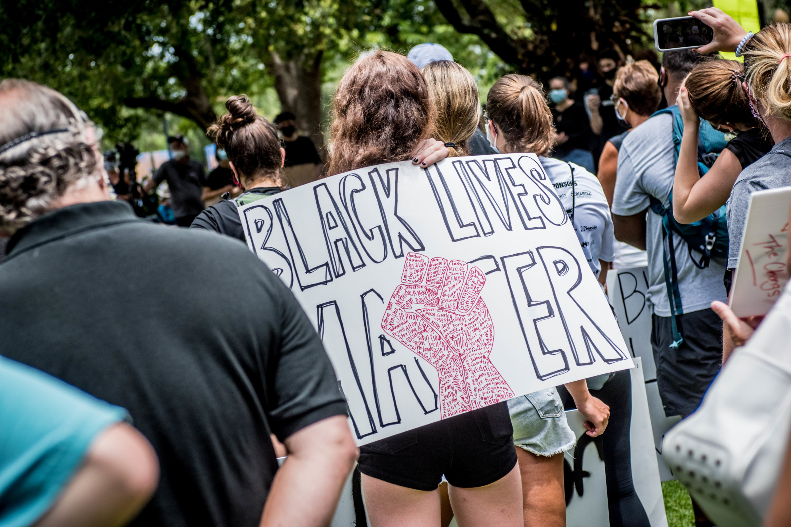 Protestor holds Black Lives Matter sign.