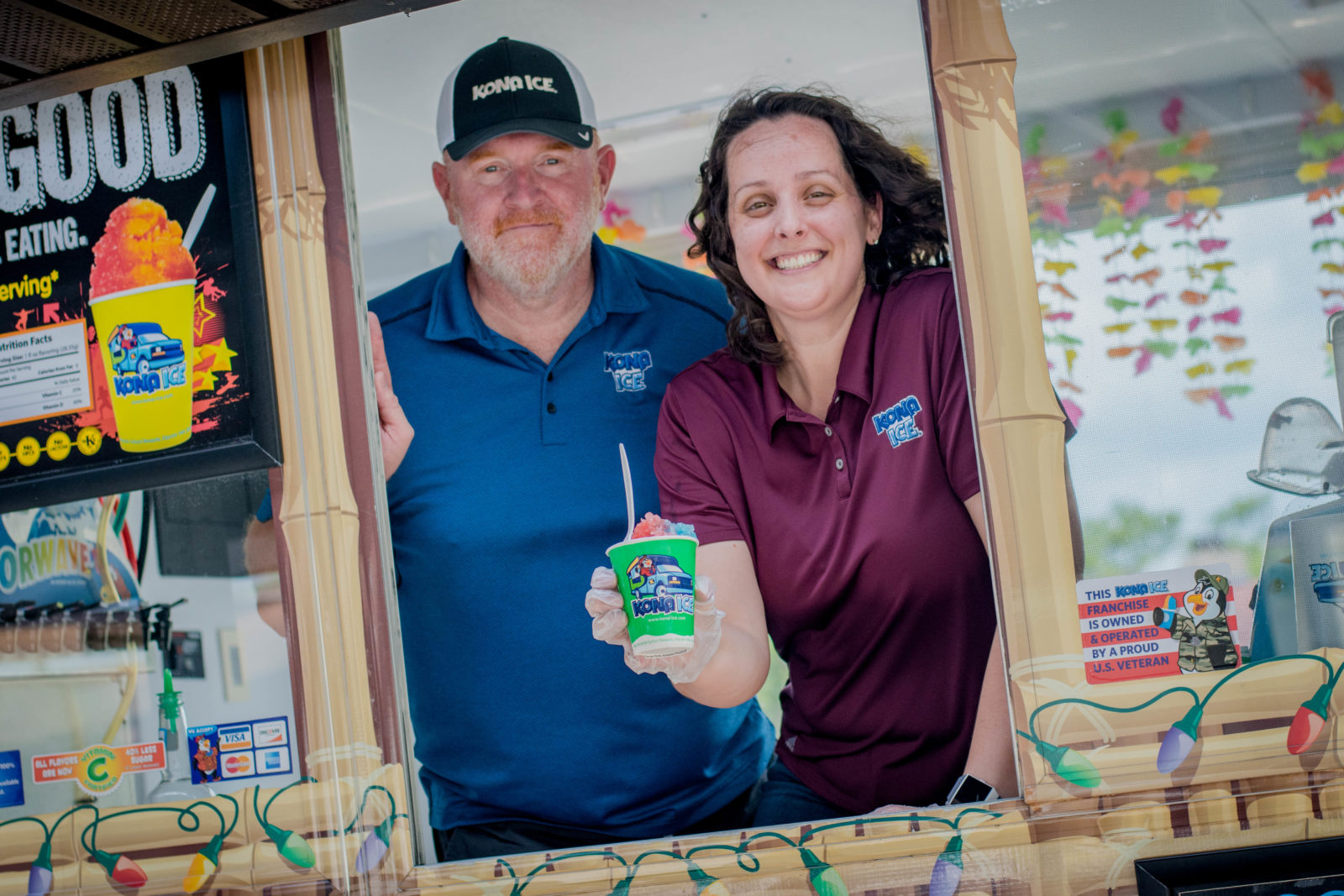 Slagle and Minton pictured in the window of the Kona Ice truck.