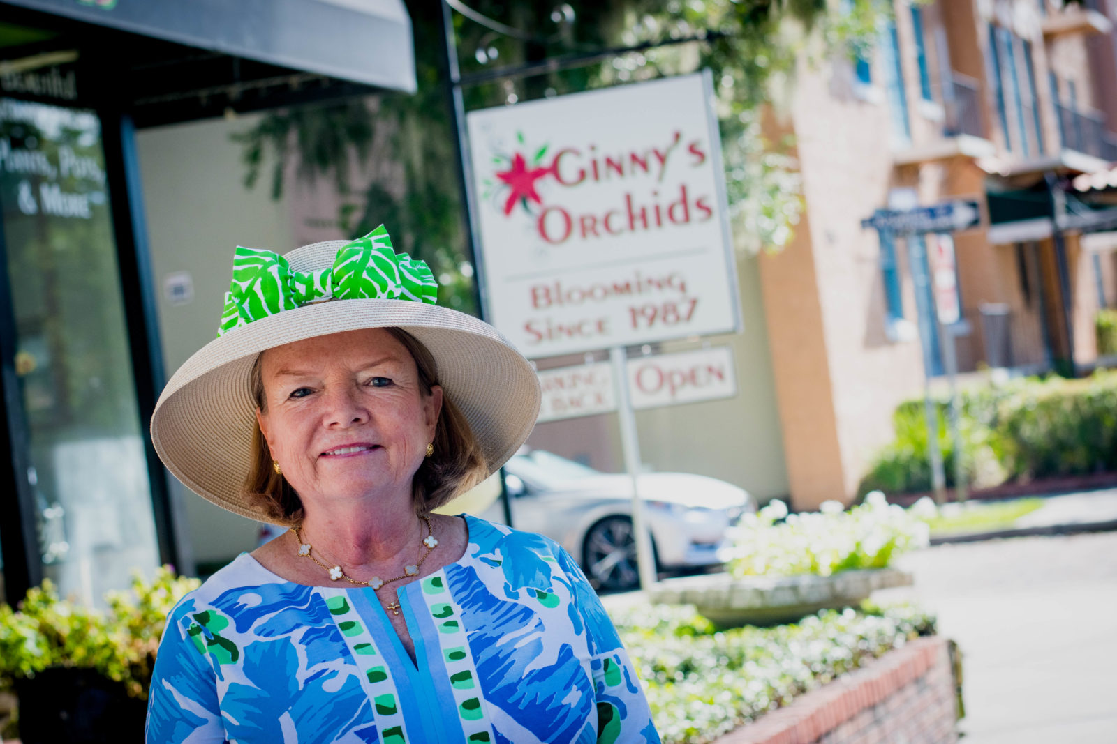 Ginny Enstad stands in front of her shop, Ginny's Orchids, located on Morse Boulevard.