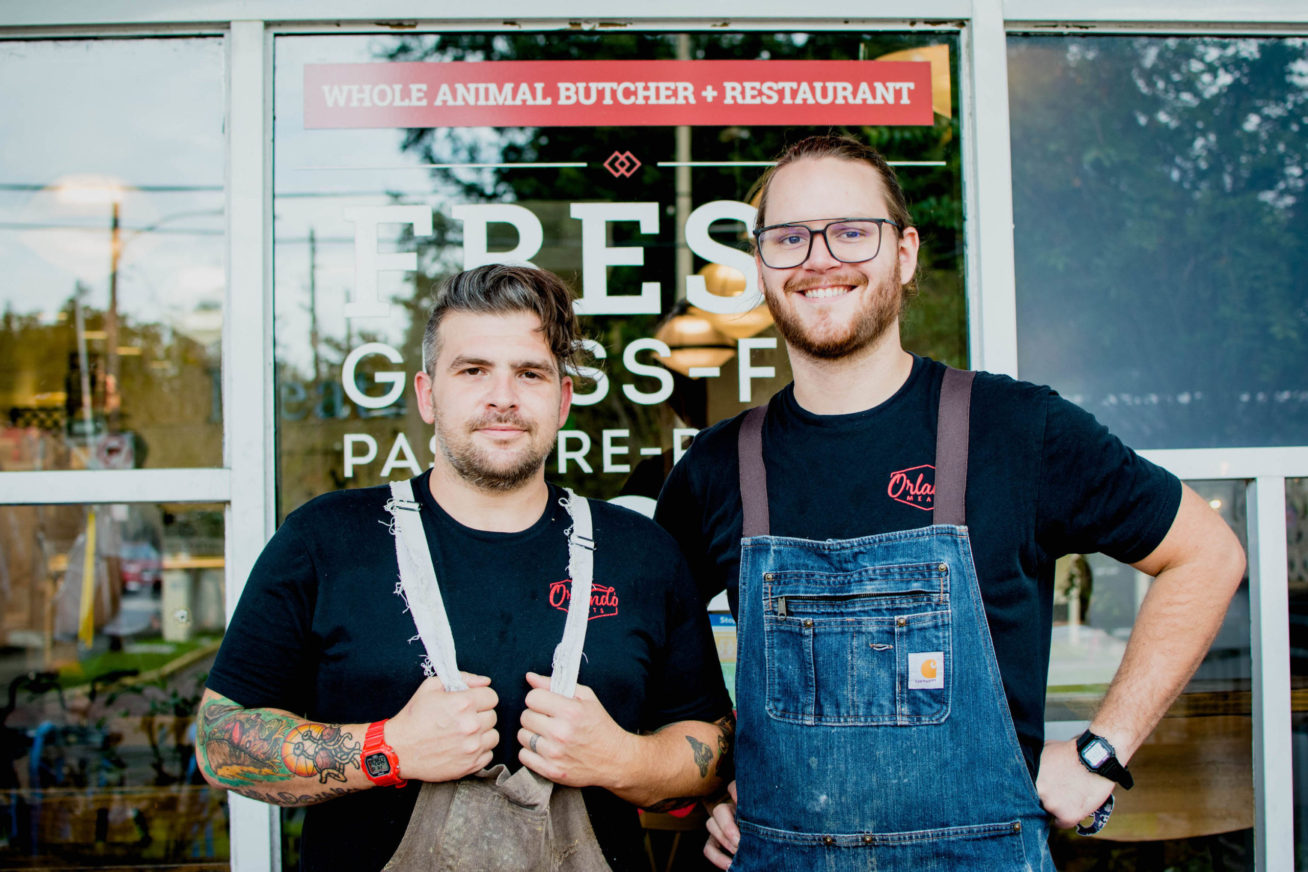 Seth Parker and Eliot Hillis stand in front of Orlando Meats.