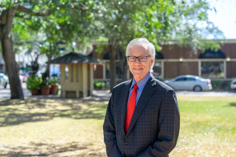 Mayor Phil Anderson stands outside of the courthouse with red tie.