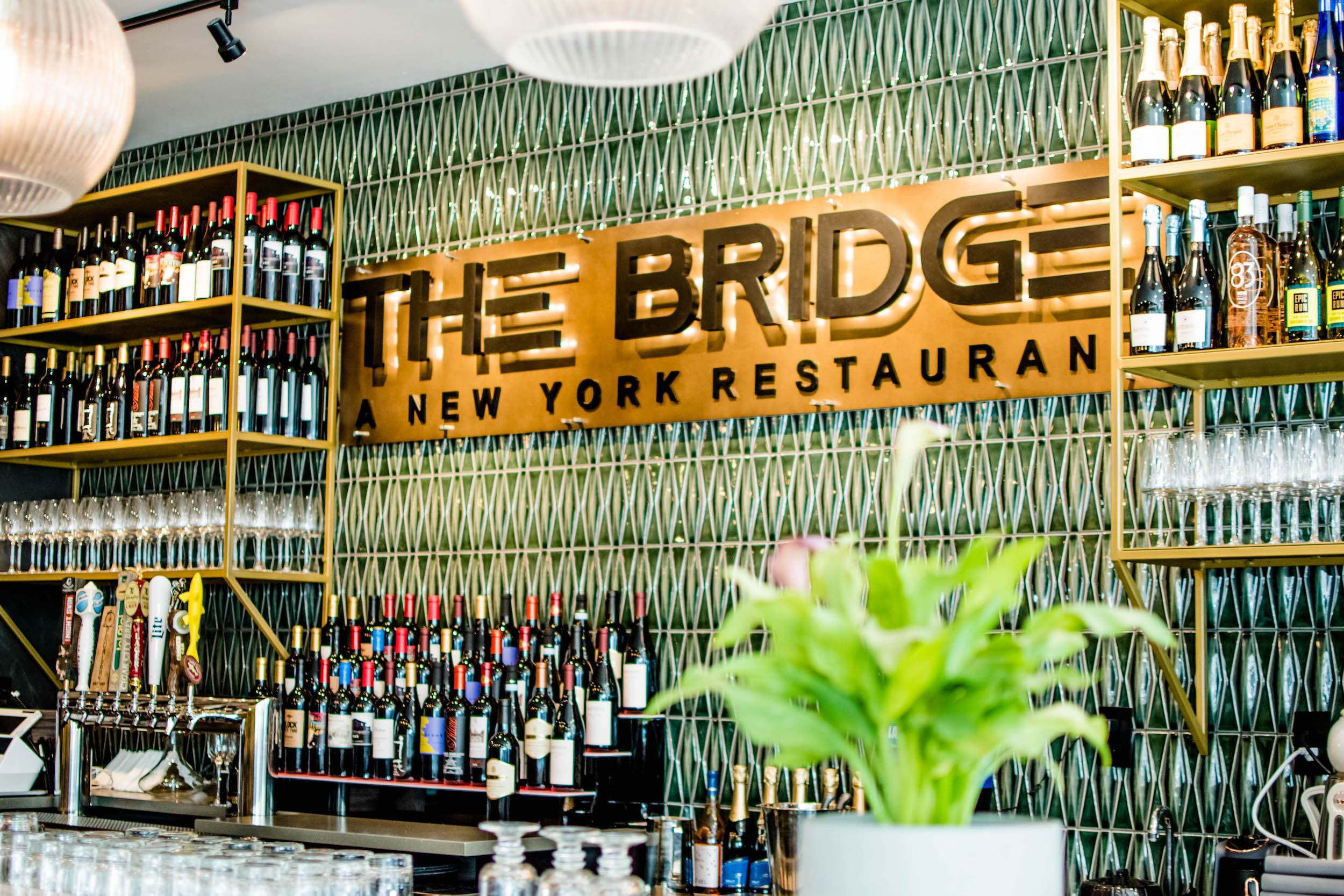 Sign that reads The Bridge above the bar of a restaurant.