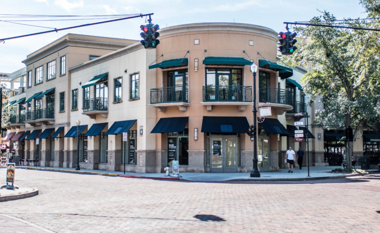 Image shows brick storefront buildings on Park Avenue.