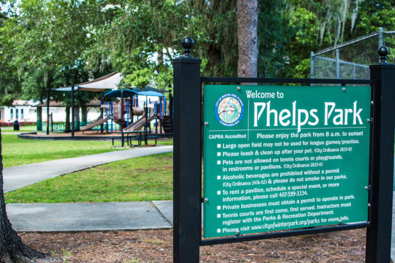 Phelps Park sign in front of the former playground.